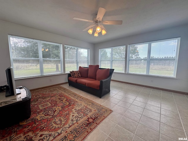 tiled living room featuring ceiling fan and plenty of natural light