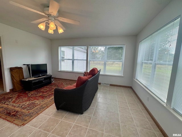 tiled living room with ceiling fan