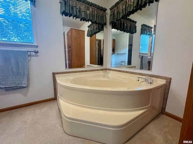 bathroom featuring a tub to relax in