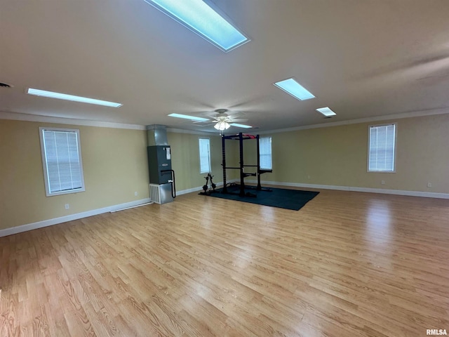 unfurnished room with ornamental molding, ceiling fan, and light hardwood / wood-style flooring