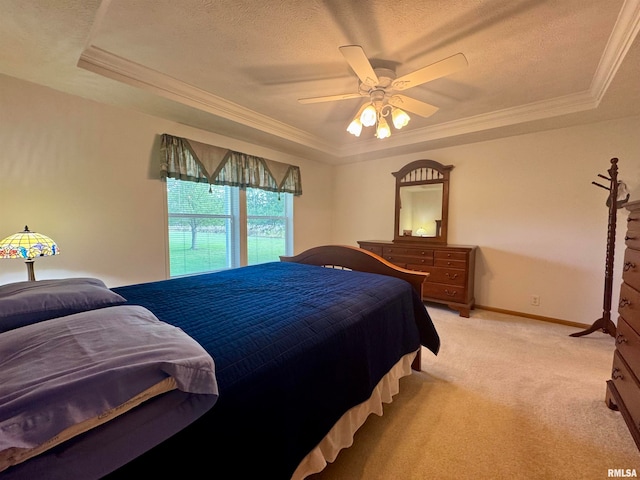 bedroom featuring ceiling fan, light colored carpet, a raised ceiling, and crown molding