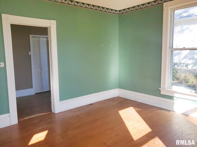 unfurnished room with wood-type flooring