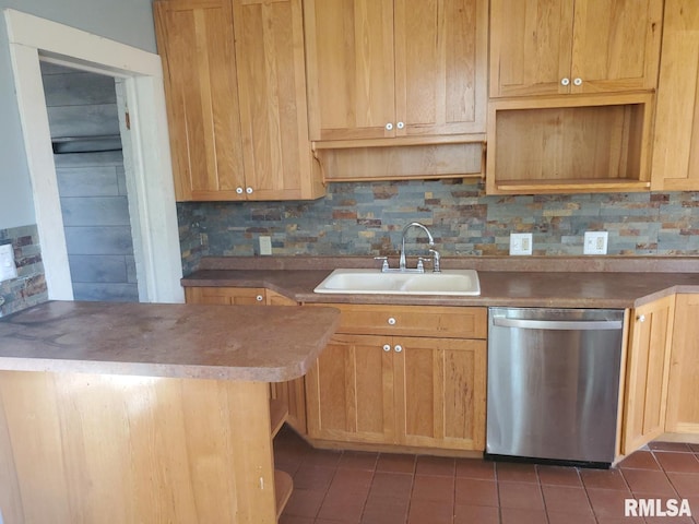 kitchen featuring tasteful backsplash, dishwasher, dark tile patterned floors, and sink