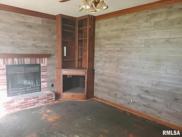 unfurnished living room with ceiling fan, wood walls, ornamental molding, and a brick fireplace