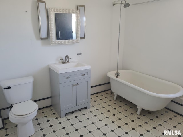 bathroom with vanity, toilet, baseboard heating, and a tub