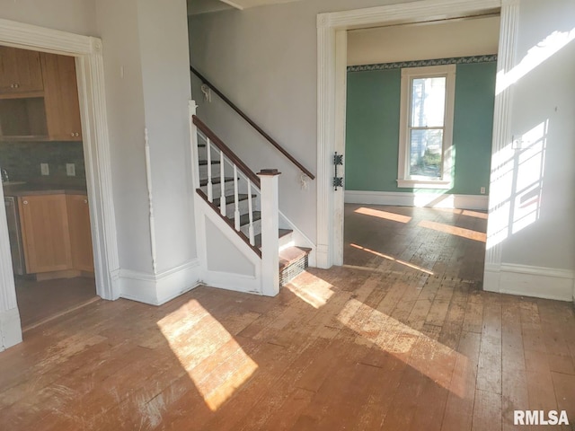 staircase with wood-type flooring