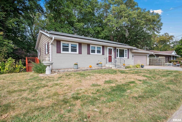 view of front of house featuring a front lawn and a garage