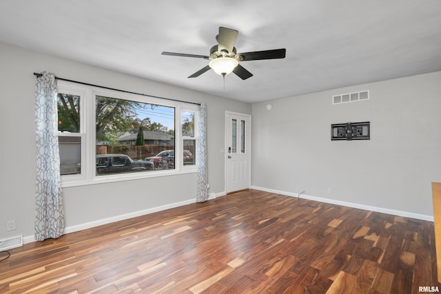 empty room with ceiling fan and hardwood / wood-style flooring