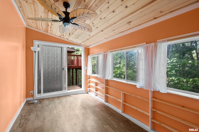 unfurnished sunroom featuring ceiling fan, vaulted ceiling, and wooden ceiling