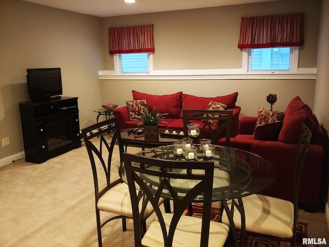 carpeted dining area with a fireplace