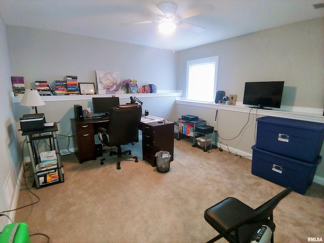 carpeted home office featuring ceiling fan