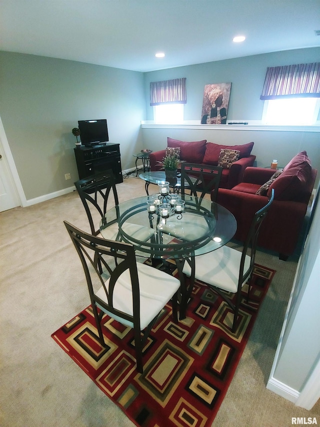 carpeted dining area with plenty of natural light