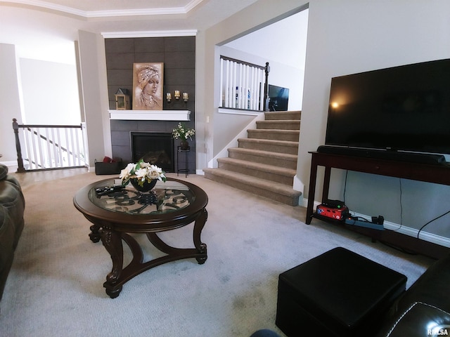 carpeted living room with a tile fireplace and ornamental molding