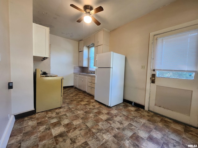 kitchen featuring sink, white cabinetry, white appliances, and ceiling fan