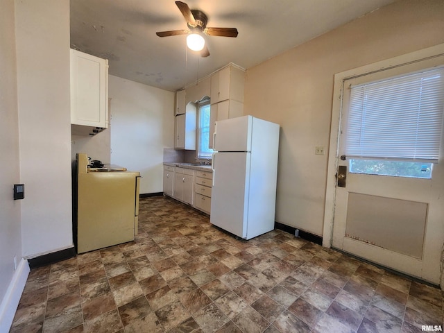 kitchen with sink, white cabinets, white appliances, and ceiling fan