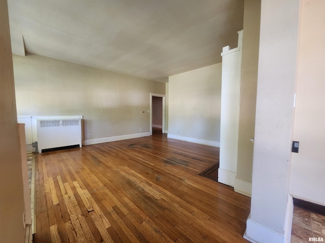 spare room with hardwood / wood-style floors and radiator