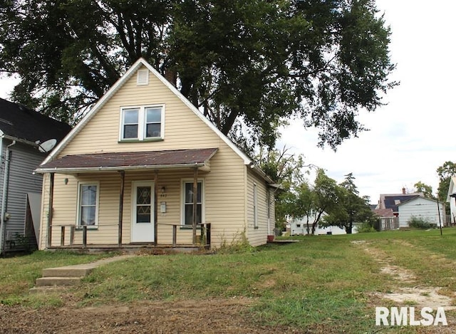 bungalow-style home with a front lawn and covered porch