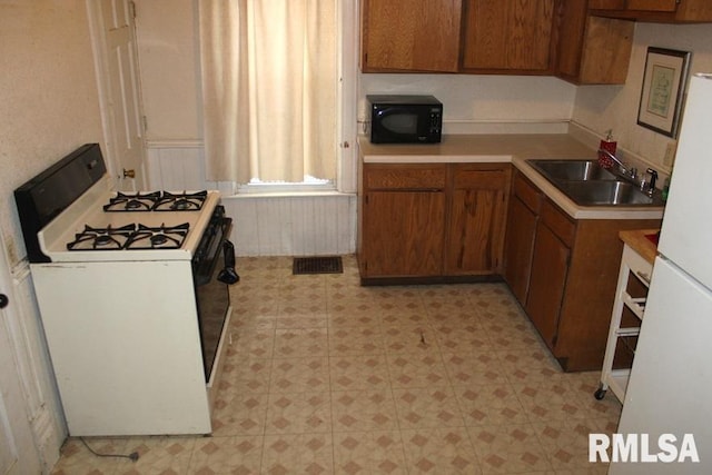 kitchen with sink and white appliances