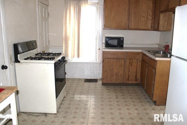 kitchen with white appliances and sink