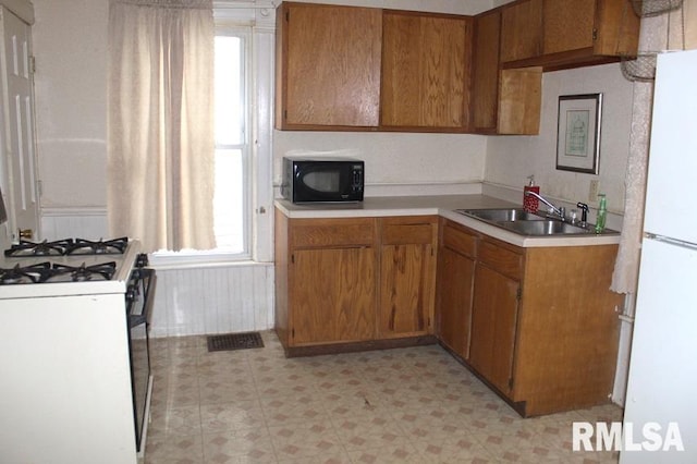 kitchen with white appliances and sink