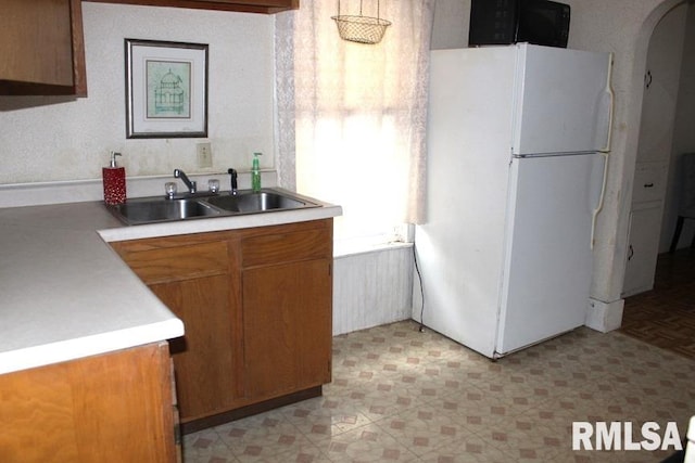 kitchen featuring sink and white refrigerator