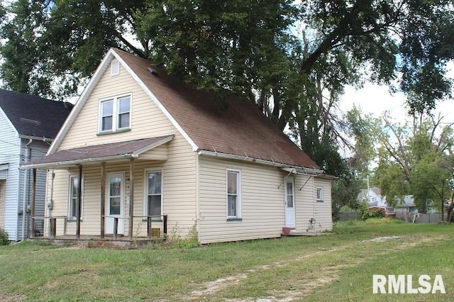 exterior space featuring covered porch and a yard