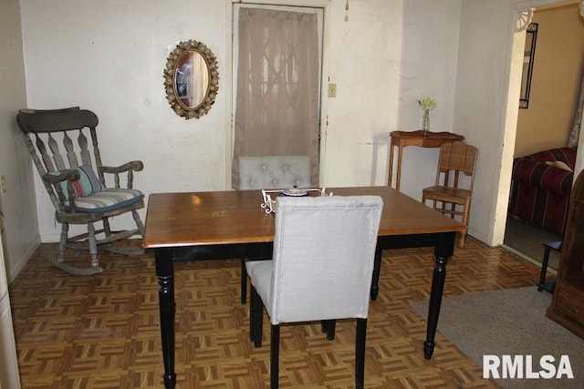 dining room featuring dark parquet floors