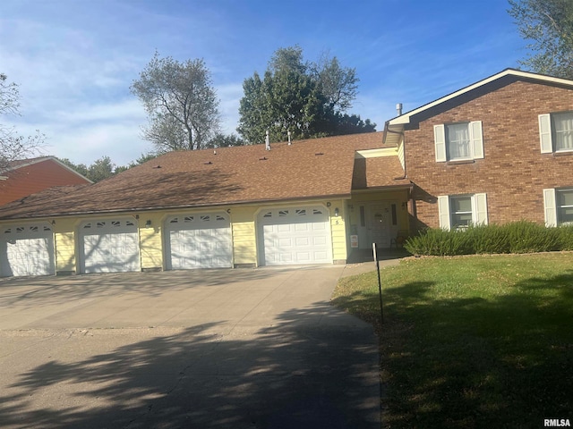 view of front of property with a garage and a front lawn