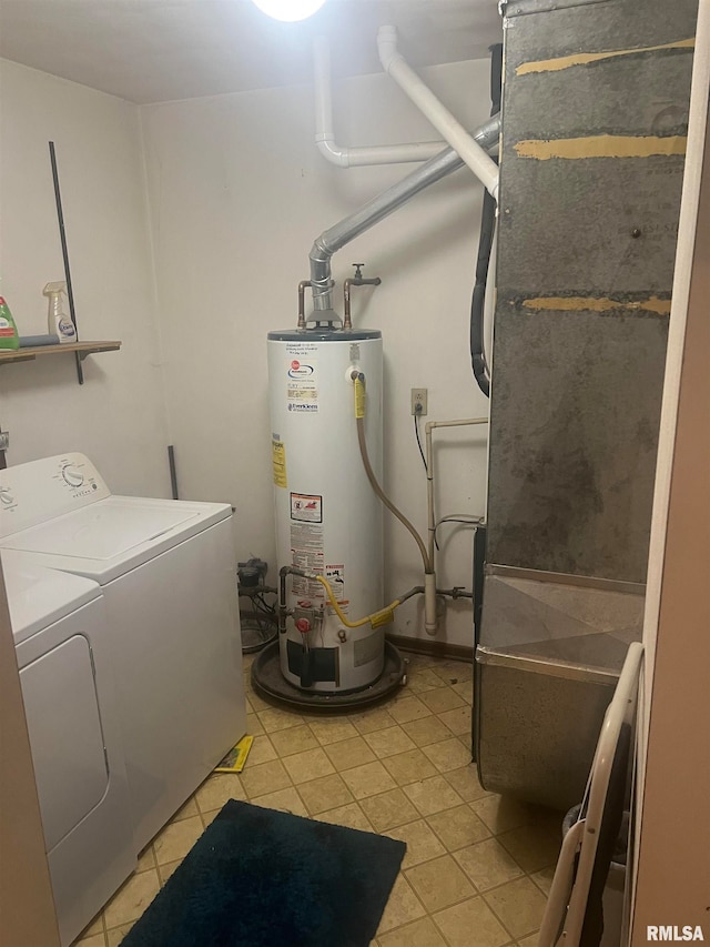 washroom featuring gas water heater, heating unit, light tile patterned floors, and washing machine and dryer