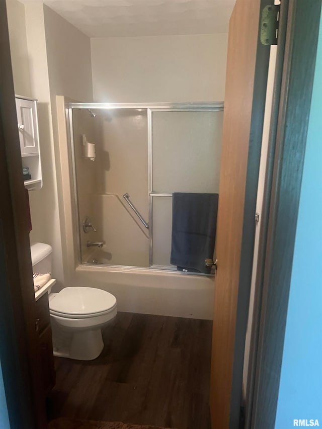 full bathroom featuring shower / bath combination with glass door, vanity, toilet, and hardwood / wood-style flooring