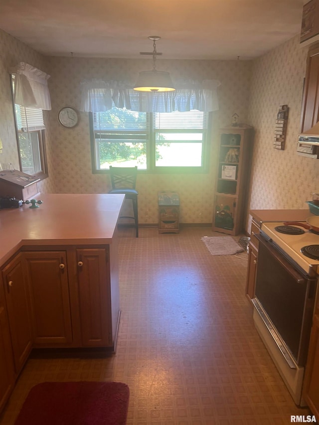 kitchen featuring white range with electric cooktop and decorative light fixtures