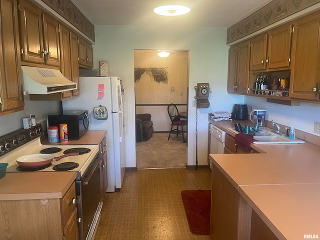 kitchen featuring sink and white appliances