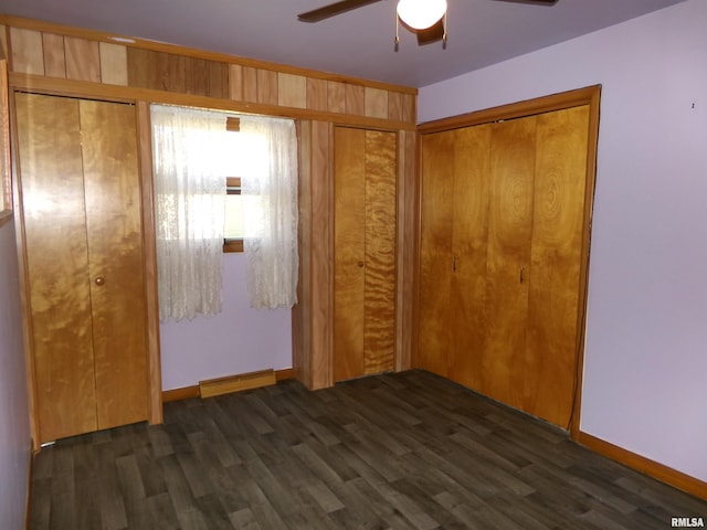 unfurnished bedroom featuring dark hardwood / wood-style floors and ceiling fan