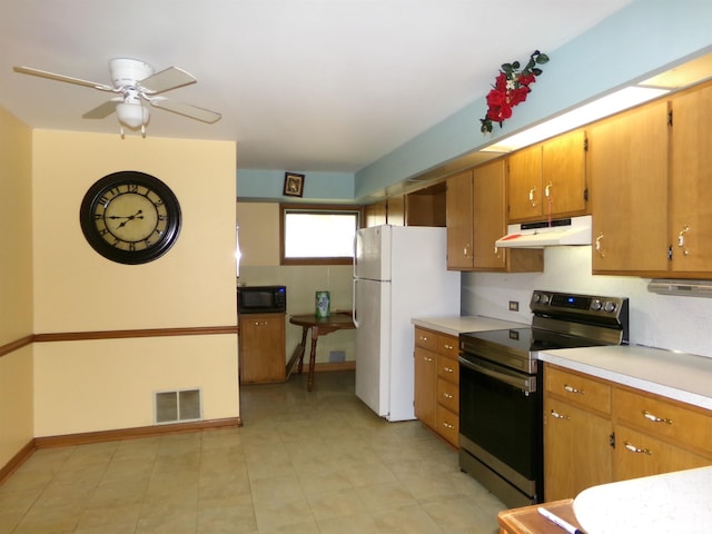 kitchen with stainless steel range with electric cooktop, white fridge, and ceiling fan