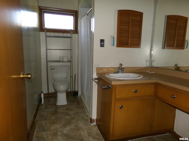 bathroom featuring walk in shower, vanity, and toilet