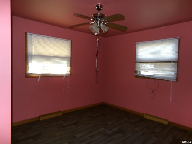 spare room with ceiling fan and dark wood-type flooring