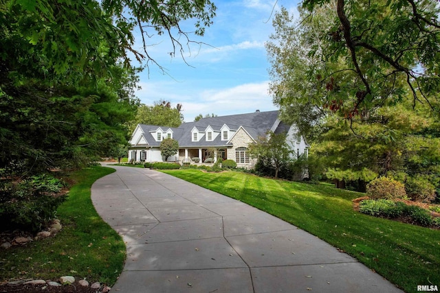 new england style home featuring a front yard