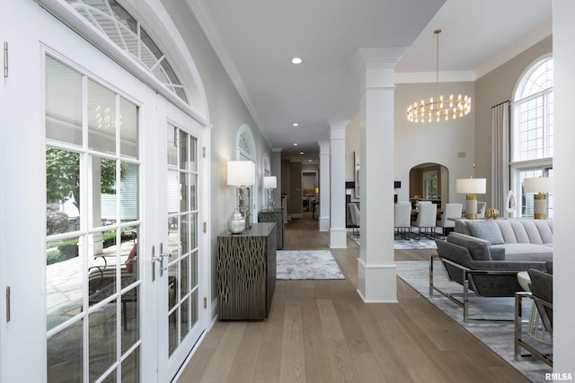 corridor with hardwood / wood-style floors, french doors, and a wealth of natural light