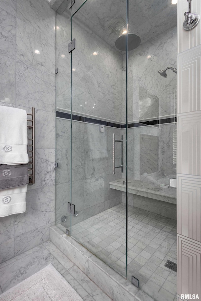 bathroom with walk in shower and tile walls