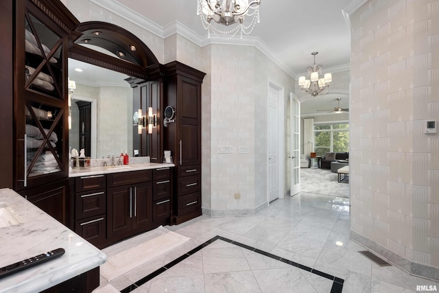 bathroom featuring vanity, ceiling fan with notable chandelier, and crown molding