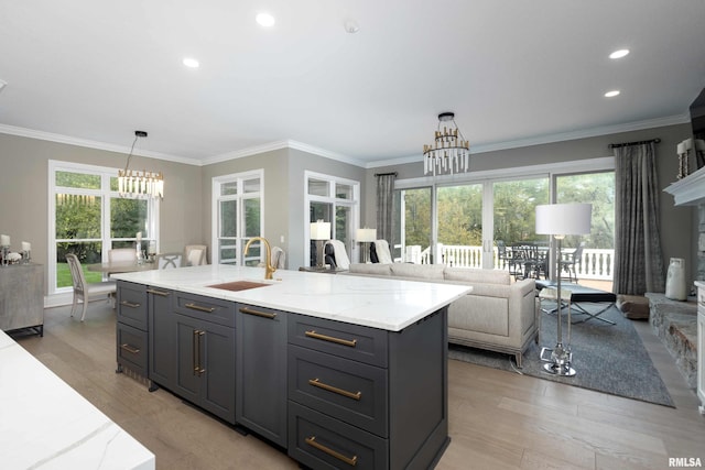 kitchen featuring ornamental molding, a wealth of natural light, and sink