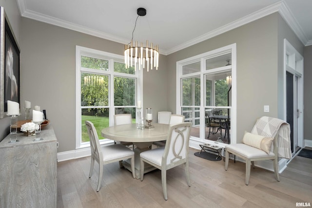 dining room with crown molding, light hardwood / wood-style floors, and a wealth of natural light