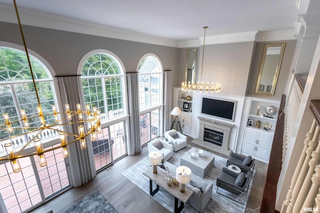 living room featuring a chandelier, hardwood / wood-style flooring, and crown molding