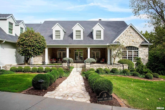 new england style home with a front yard and a porch