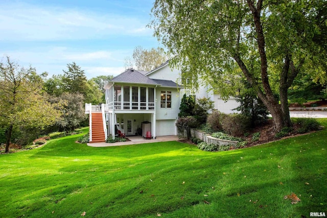 rear view of house with a garage and a yard