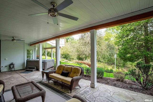 view of patio with a hot tub, an outdoor living space, and ceiling fan