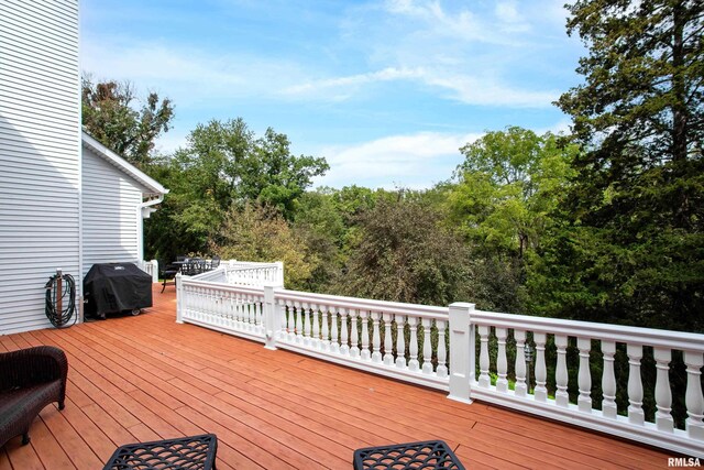 wooden deck with a grill