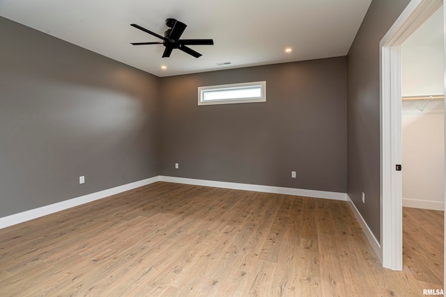 empty room featuring light wood-type flooring and ceiling fan