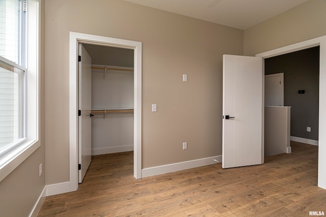 unfurnished bedroom featuring light hardwood / wood-style floors and a closet