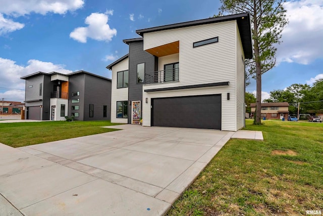 contemporary home featuring a balcony, a front yard, and a garage